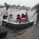 People in Houston use an air mattress to float down a flooded street Aug. 27, 2017, as they evacuate their homes after the area was inundated with flooding from Hurricane Harvey. (Joe Raedle/Getty Images)